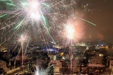 Vivid fireworks light up the sky over Reykjavik, celebrating the festive spirit of the Icelandic New Year's Eve Walking Tour