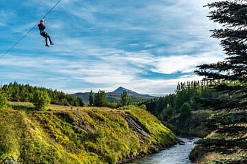 With the local mountain, Súlur, in the background on zipline 3 of 5 on our tour.
