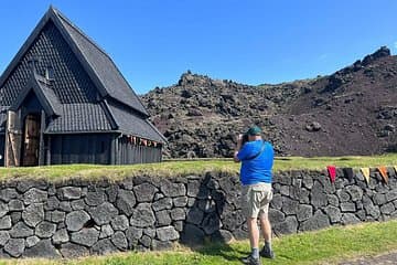 Traveler taking pictures of the Viking black church