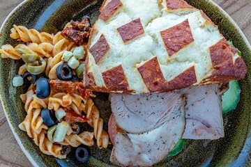 A vibrant spread of pasta, meats, and salads from the Geysir Glíma Restaurant