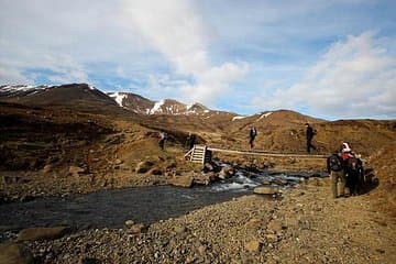 Hikers crossing a bridge