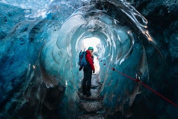 Admire the intricate textures and ancient air bubbles trapped within the walls of the ice cave