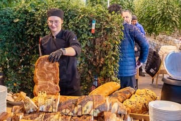 Cutting the delicious bread at Friðheimar Tomato Farm